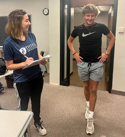 MS-SLP Student Christa Reese conducts stanardized concussion baseline testing on soccer athelete Tyler Davy.