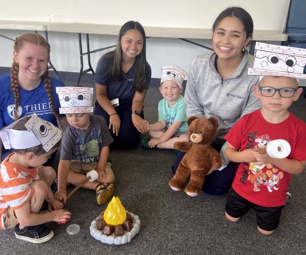 Emma Dietz, Camille Fabian , and Isabella Nervarez work with chidren in the Talking Tomcats preschool therapy group to promote communicaiton, social interaction and speech and language development through engaging activities.