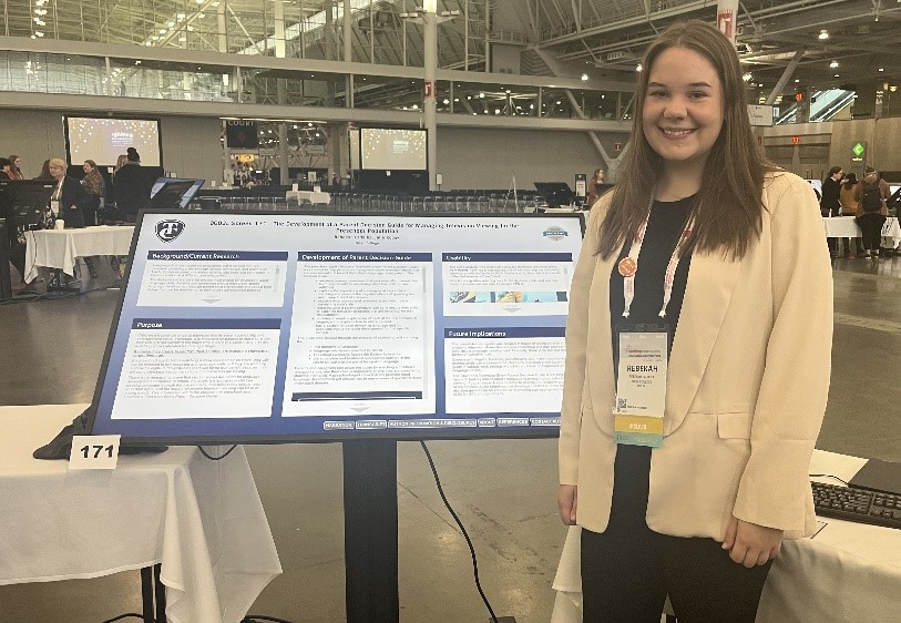 Rebekah Ladaika, MS-SLP student, presents her poster at the 2023 ASHA Convention.