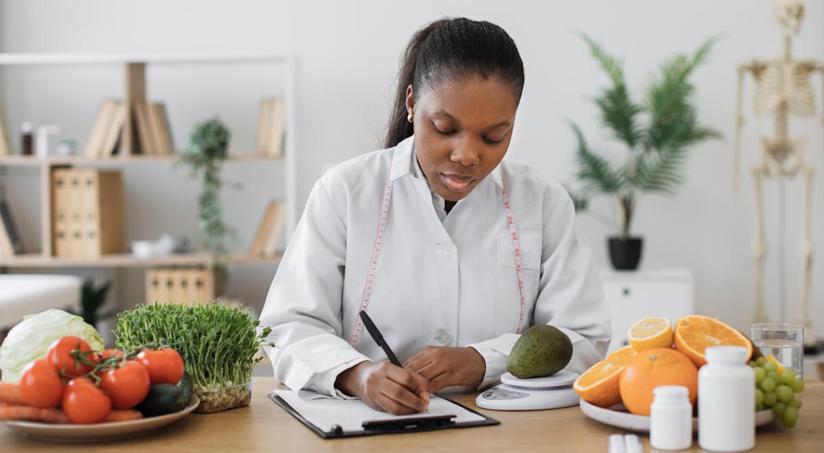 dietitian measuring avocado on scale at office