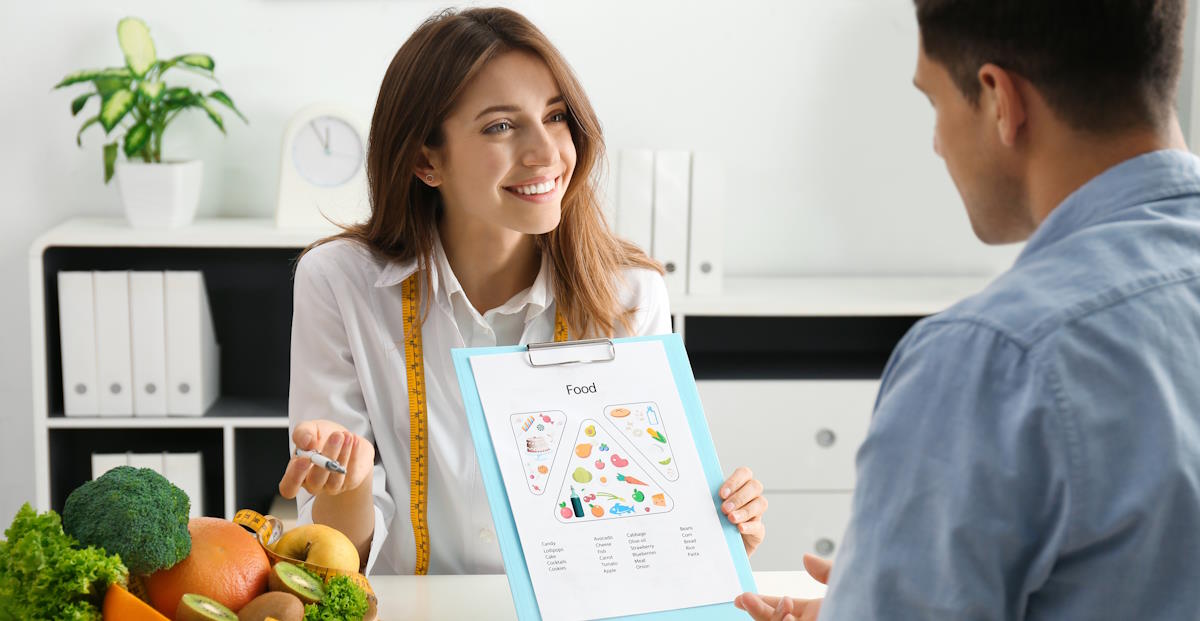 young nutritionist consulting patient at table